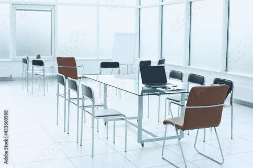 Flipchart glass table chairs in office space. The concept of training in the office of a large company