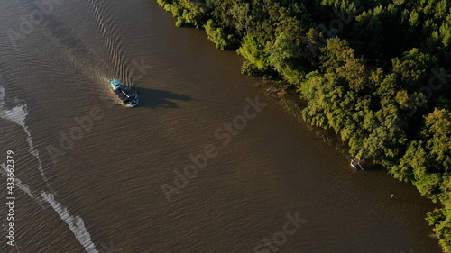 Top down shot of cargo ship navigating River in South America