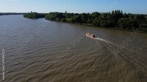 Tourist boat sailing through amazon river during sunny day. photo