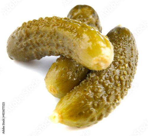 Three pickled cucumbers are isolated on a white background. Salted cucumbers.