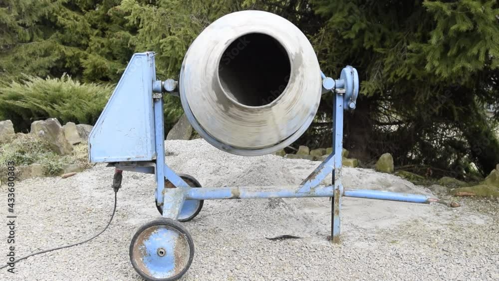 Mixing cement in a concrete mixer Mixing cement in a concrete mixer