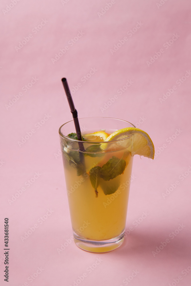 on the table, soft drinks, various cocktails, a glass with a straw and a slice of lemon, a blurred background on the table, soft drinks, various cocktails, a glass with a straw and a slice of lemon, a blurred background