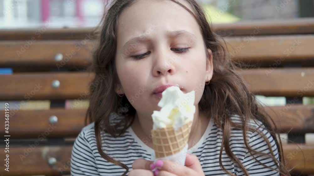 4k. Cute caucasian little girl eating ice cream cone in Park 4k. Cute caucasian little girl eating ice cream cone in Park