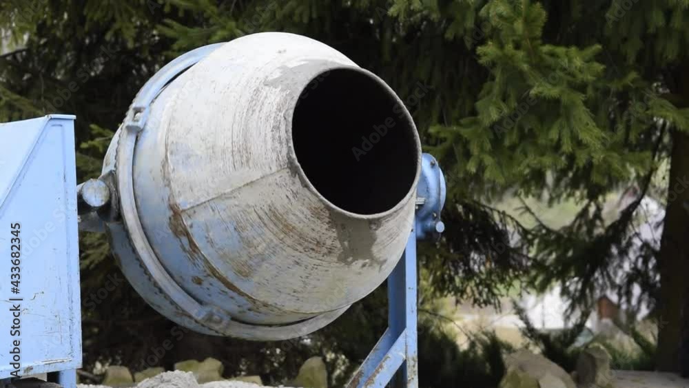 Mixing cement in a concrete mixer Mixing cement in a concrete mixer