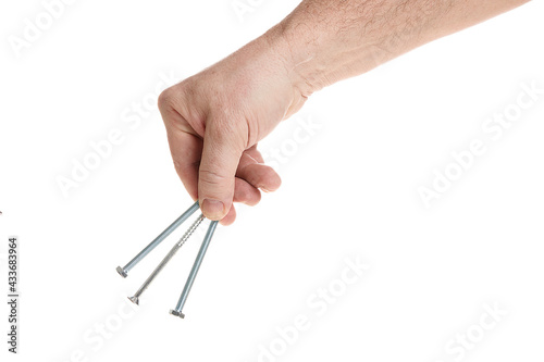 Hand holds metal screws on a white background, a template for designers.