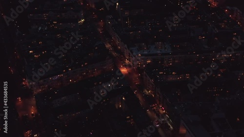 Scenic aerial Berlin city night panorama with cars in streets and illuminated block nighbourhood buildings.Aerial panning top down circling view photo