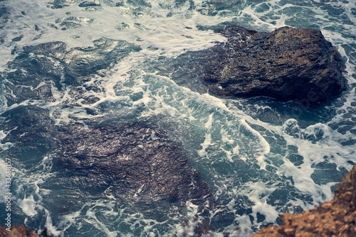 Sea waves bumping against the rocky shore
