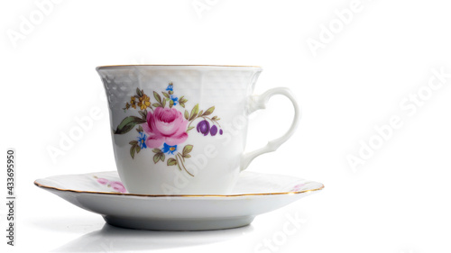 Porcelain white cup on a saucer with gilding. Isolated on a white background