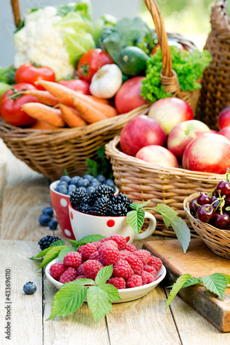 Basket of fresh fruits and vegetables, healthy organic vegetarian food on table