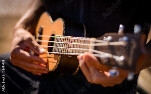 Person enjoying the beach playing an instrument