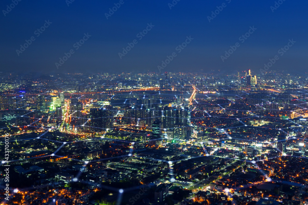 Scenic view of skyline in Seoul, South Korea, from above at night. Blockchain wireless network technology, smart city, 5G and big data concept photo. Hexagon pattern on cityscape.
