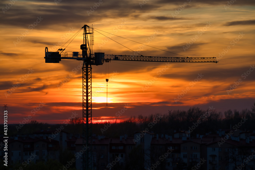 Fototapeta premium Construction crane silhouette at sunset