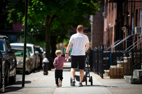 father and son walking together on a sunny day