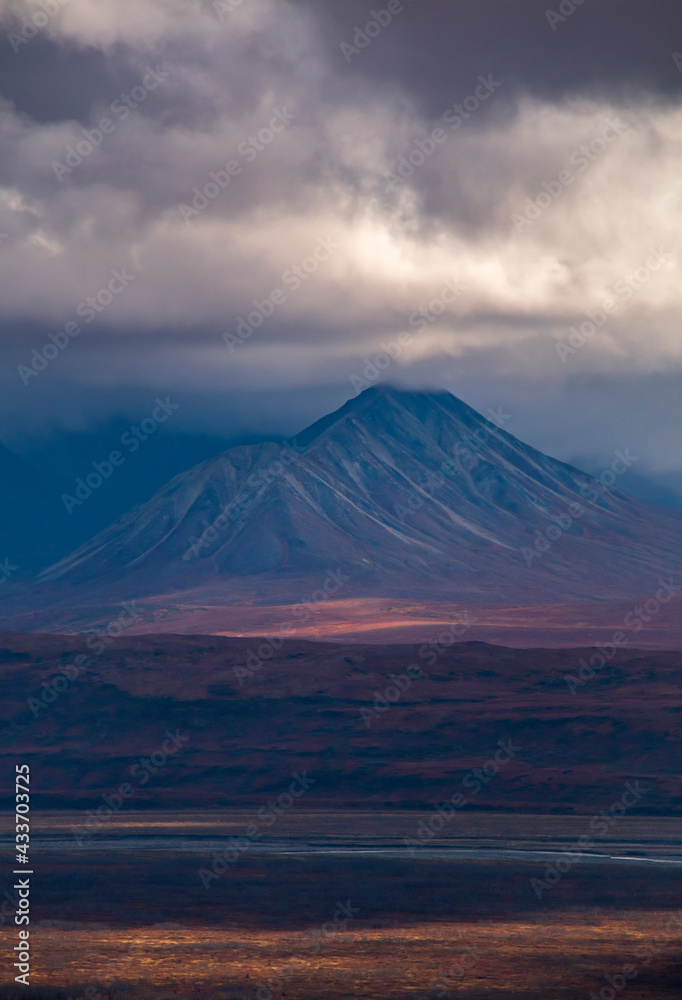 dramatic landscape of mountain peaks and mountain ranges inside Denali National Park during autumn season. dramatic landscape of mountain peaks and mountain ranges inside Denali National Park during autumn season.