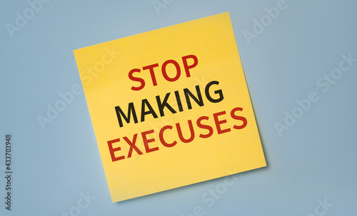 Stop Making Excuses printed on a sticker as a reminder. Motivation and incentive for starting ta act and change your life.