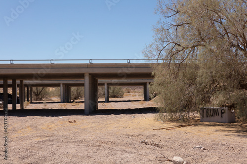 Dry wadi passing under a railway bridge in the arid Mojave Desert