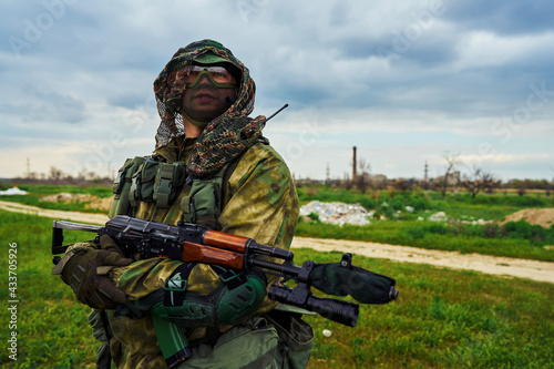 Close-up of a Russian soldier holding a weapon in his hands