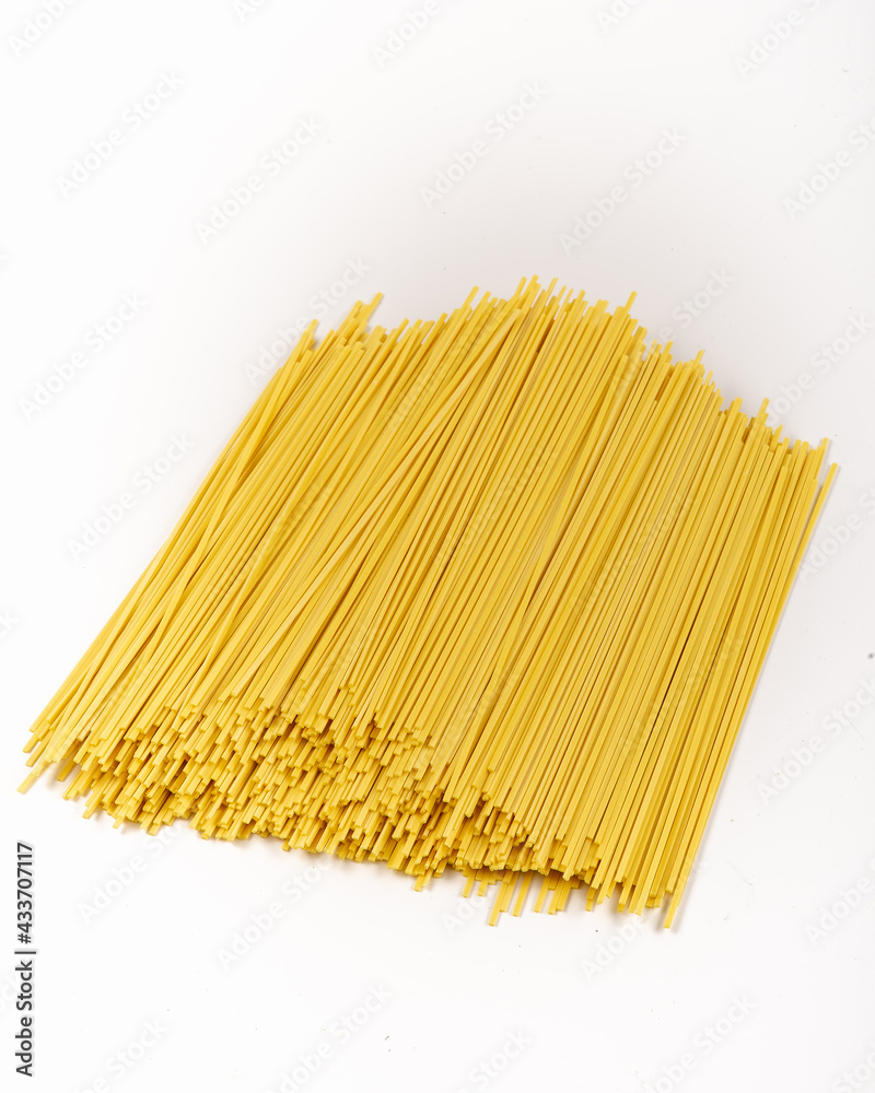 Raw whole grain spaghetti isolated on white background. Raw ramen noodles. Photo for site. Raw whole grain spaghetti isolated on white background. Raw ramen noodles. Photo for site.