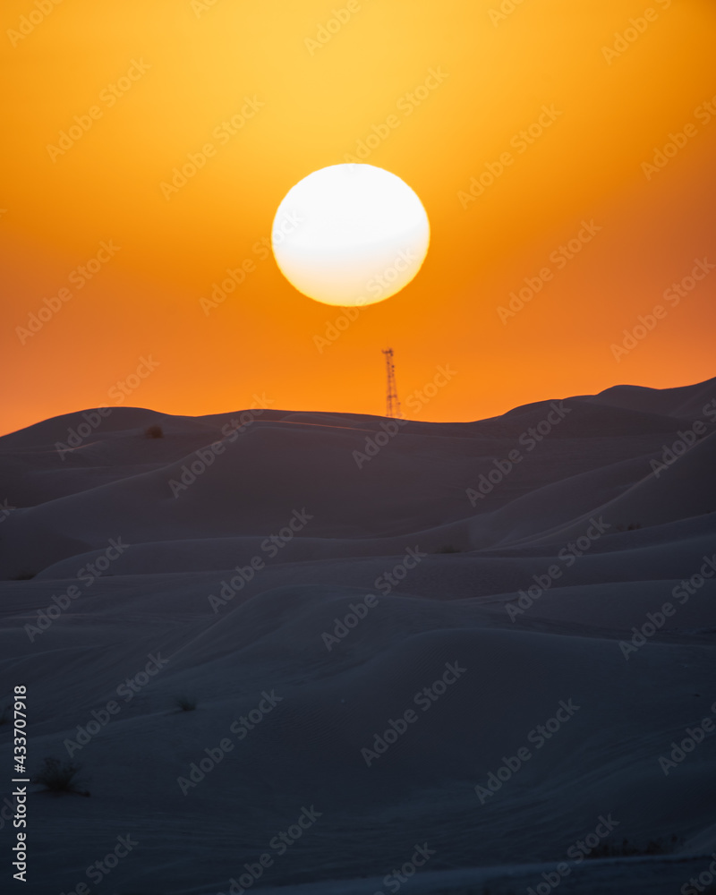 A  view of desert dunes at sunset