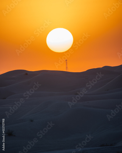A view of desert dunes at sunset