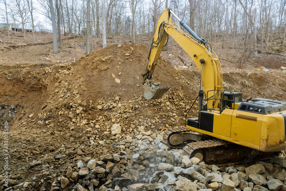 Excavator front loader with a bucket filled with crushed stone Excavator front loader with a bucket filled with crushed stone
