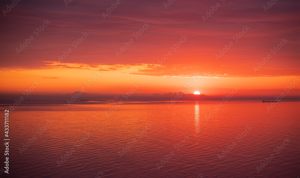 Magic of the morning the first rays of the rising sun in pink and orange colors of a summer day while on vacation. Meditation and relaxation