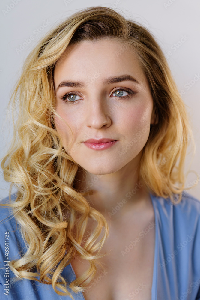Fototapeta premium Woman with long curly hair and absolutely clear skin