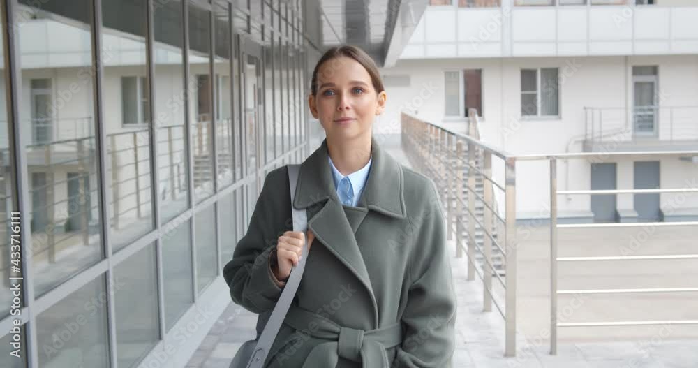 Beautiful woman going to work walking near business center Beautiful woman going to work walking near business center