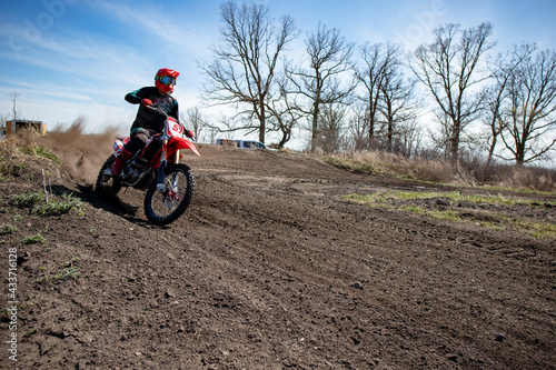 Motocross rider exits a corner with great speed.