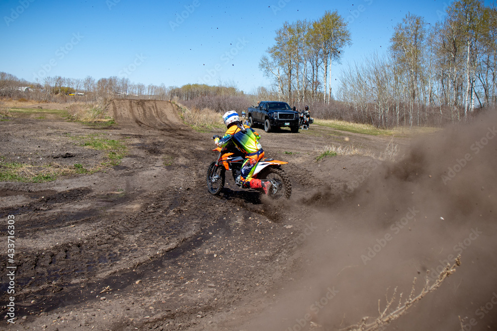 Dirt biker almost falls off bike drifting through a corner. Dirt biker almost falls off bike drifting through a corner.
