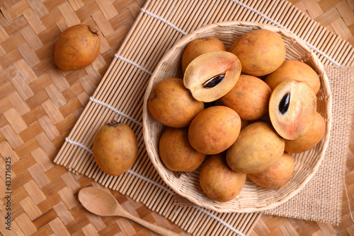 Sapodilla fruit (Manilkara zapota) and other names such as sapota, chikoo, chico, naseberry, or nispero. Sapodilla is tropical fruit evergreen tree and sweet taste fruit photo