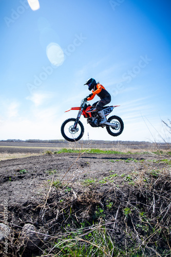 Motocross rider about to land a jump.