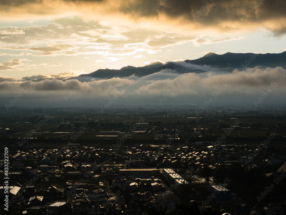 Naklejka premium Sunset over Matsumoto city and Northern Alps, scenic view from Joyama park observation tower - Nagano prefecture, Japan
