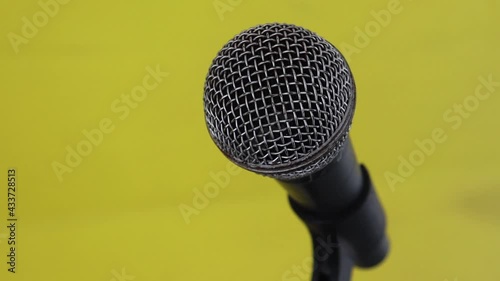 Concert microphone on the stage  bright lights. Music instrument concept.