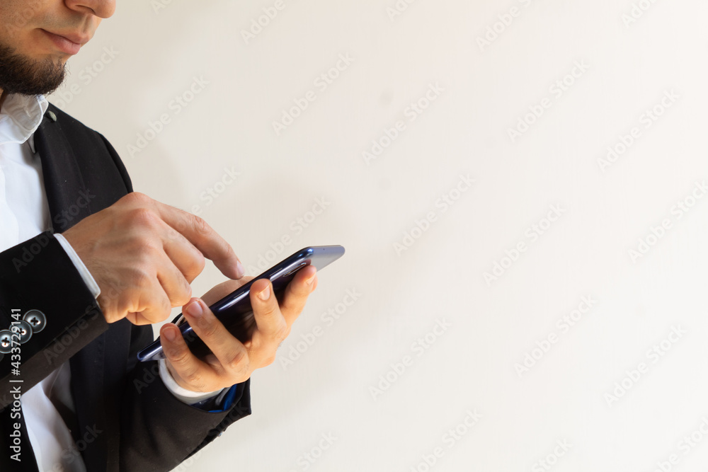 hands of a businessman in a black suit using a smartphone hands of a businessman in a black suit using a smartphone