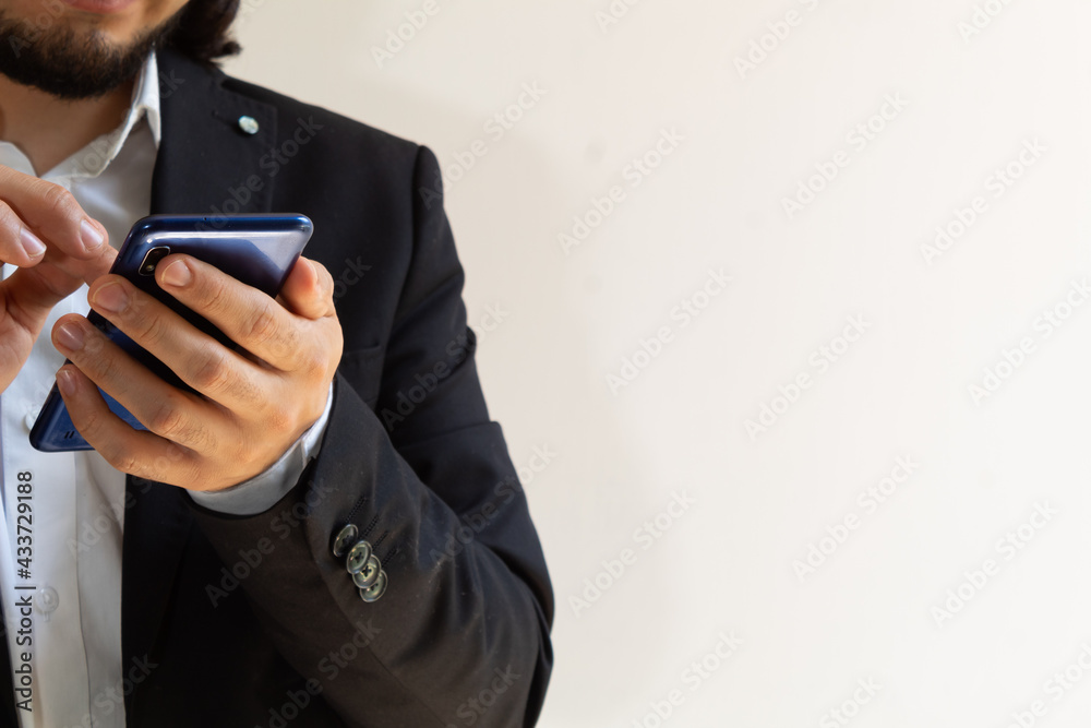 hands of a businessman in a black suit using a smartphone hands of a businessman in a black suit using a smartphone