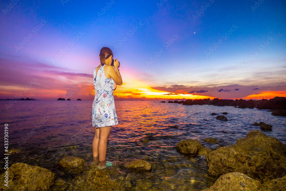 woman on the beach at sunset