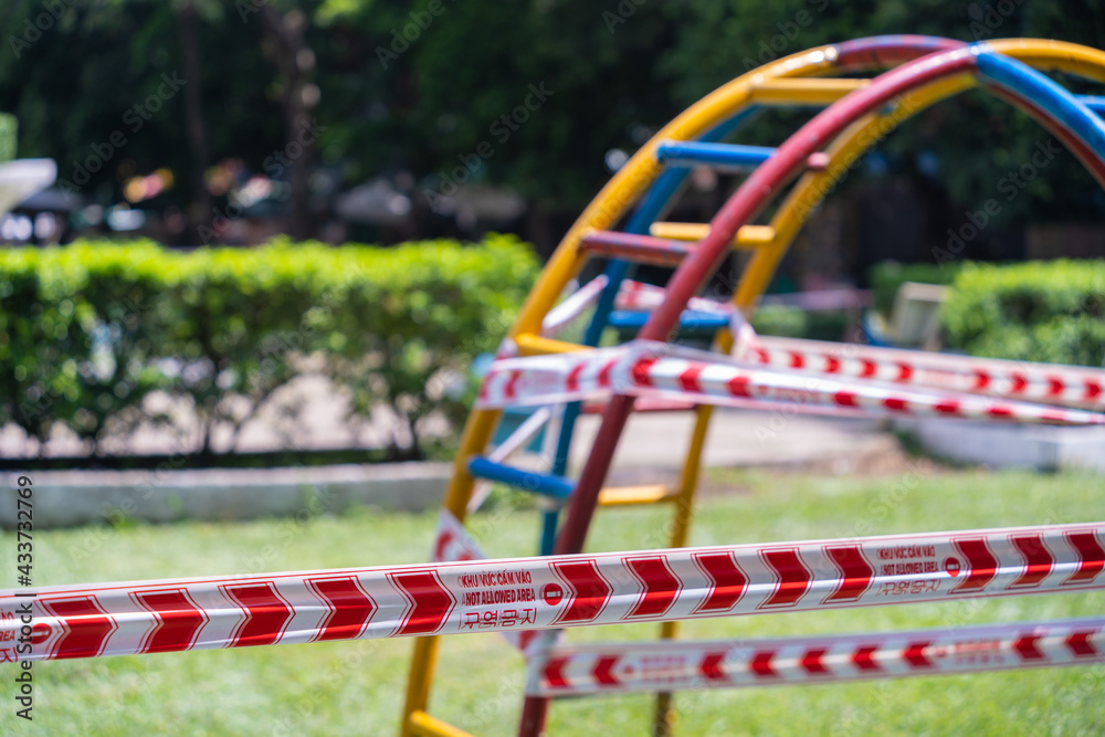 Park kids and children playground for game and activity empty and closed for Coronavirus or Covid19. And strips with word Park kids and children playground for game and activity empty and closed for Coronavirus or Covid19. And strips with word