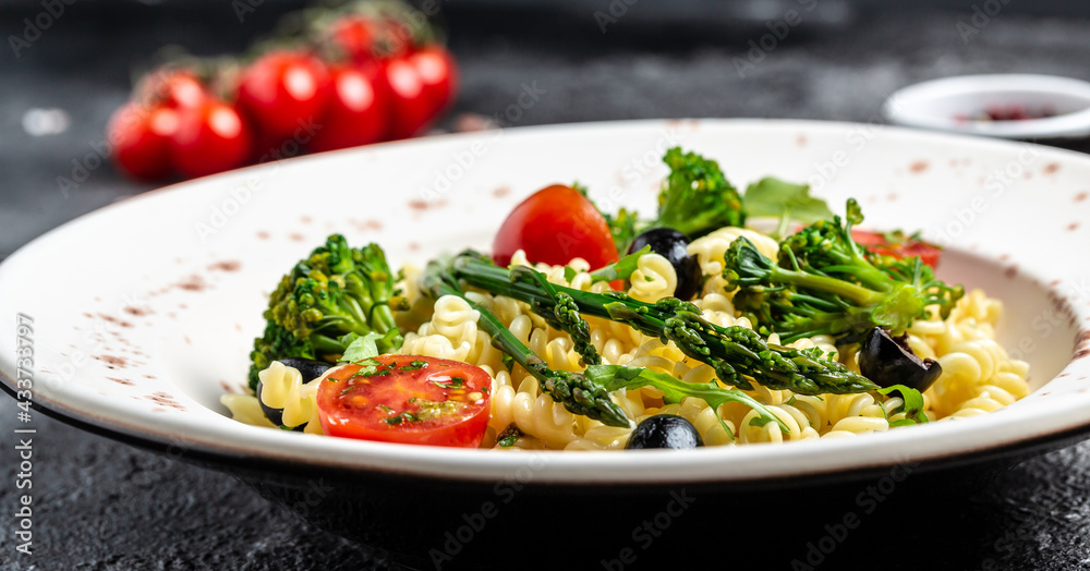 Fusilli pasta salad with fresh vegetables. Greek Salad. Long banner format, top view