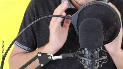 Podcast Recording. man recording voice over. An intelligent brunette male person records his voice.