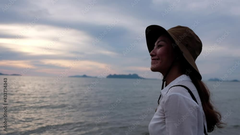 A young asian woman watching a beautiful sea view before sunset A young asian woman watching a beautiful sea view before sunset