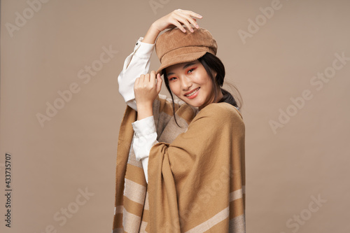 cheerful asian woman fashionable clothing lifestyle beige background