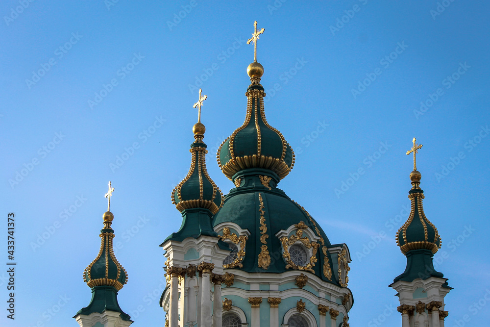 Green domes of the Kiev-Pechersk Lavra church against the blue sky