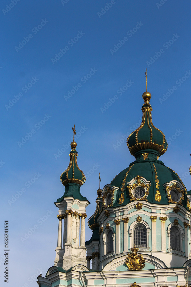 Green domes of the Kiev-Pechersk Lavra church against the blue sky