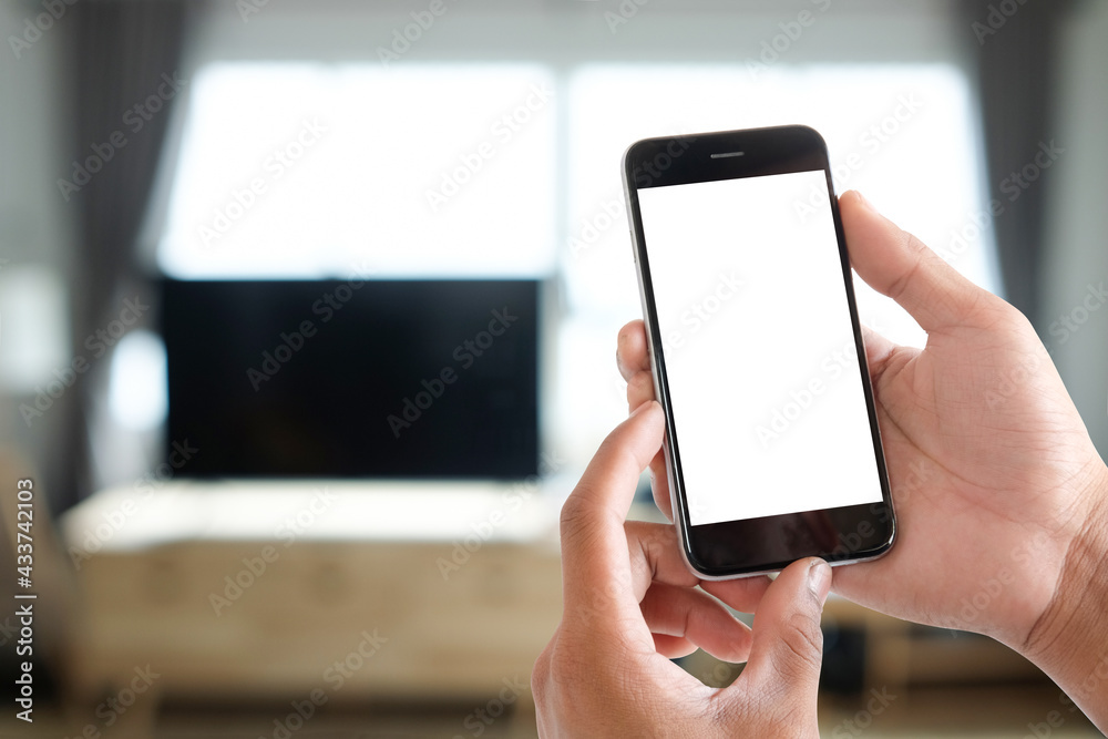 Cropped shot view of man hands holding smart phone with blank copy space screen for your text message or information content, female reading text message on cell telephone during in urban setting. 