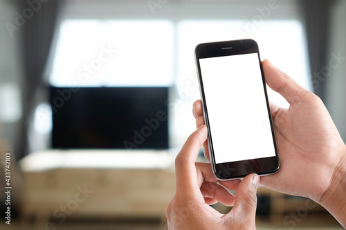 Cropped shot view of man hands holding smart phone with blank copy space screen for your text message or information content, female reading text message on cell telephone during in urban setting. 