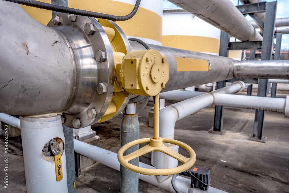 Pipes, tubes, machinery and steam turbine at a power plant Pipes, tubes, machinery and steam turbine at a power plant