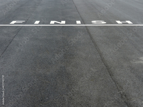 White lettering "finish" on dark asphalt