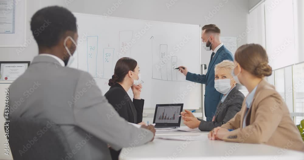 Diverse business team at training in medical face mask Diverse business team at training in medical face mask