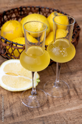 Glasses of cold sweet italian strong alcoholic liquor limoncello made from fresh lemons.